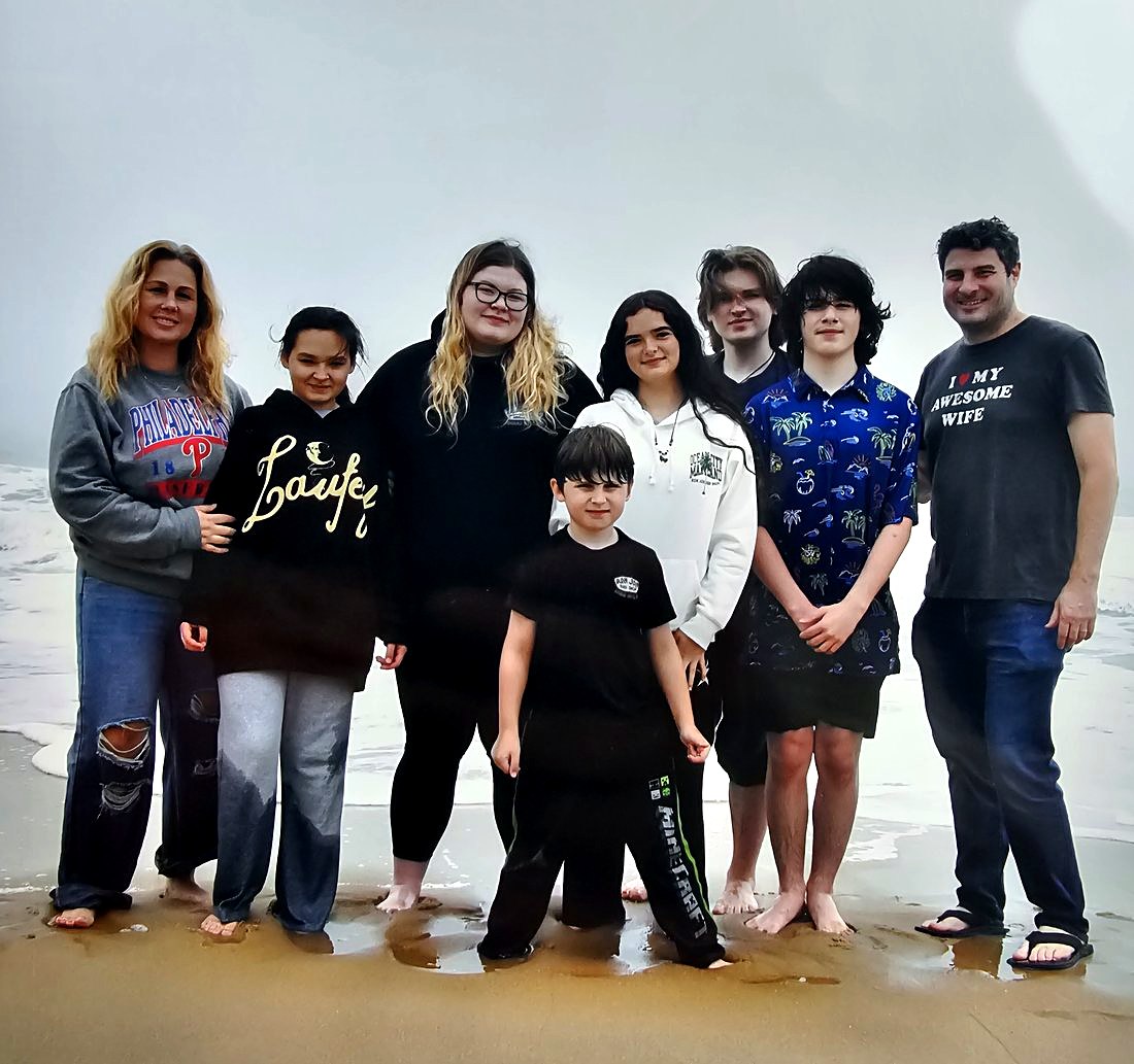 Bridget with her husband and six kids at the beach