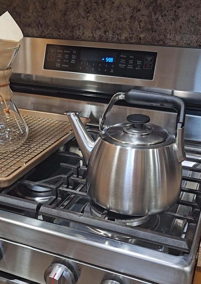 Sur La Table brushed stainless whistling kettle on the stove
